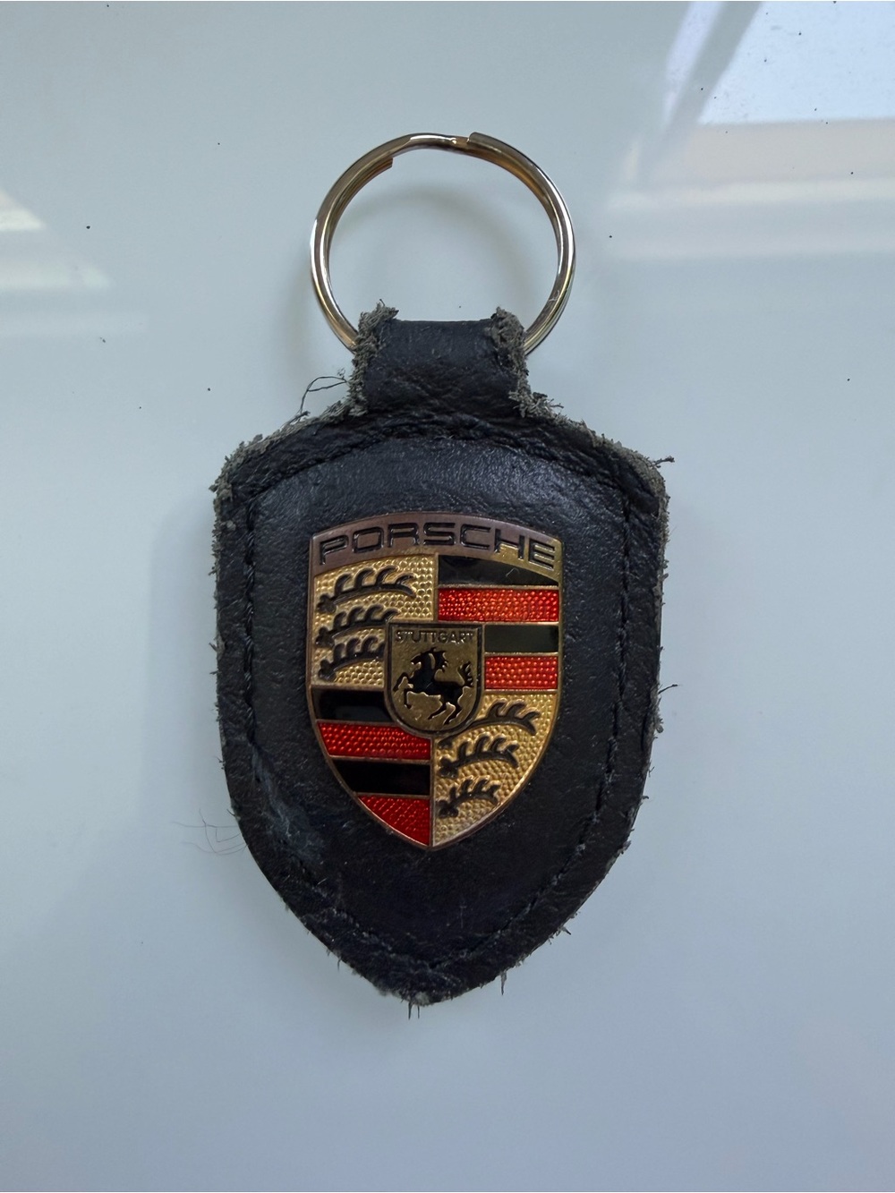 Porsche Design Black Leather Shield Keychain with Gold Crest